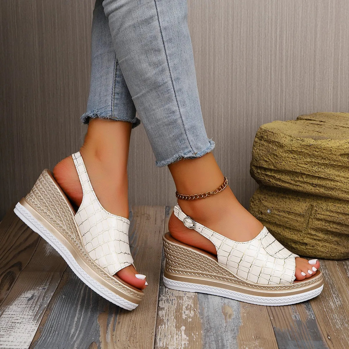 White wedge sandals worn with light blue jeans on a wooden floor-blackorvani.com