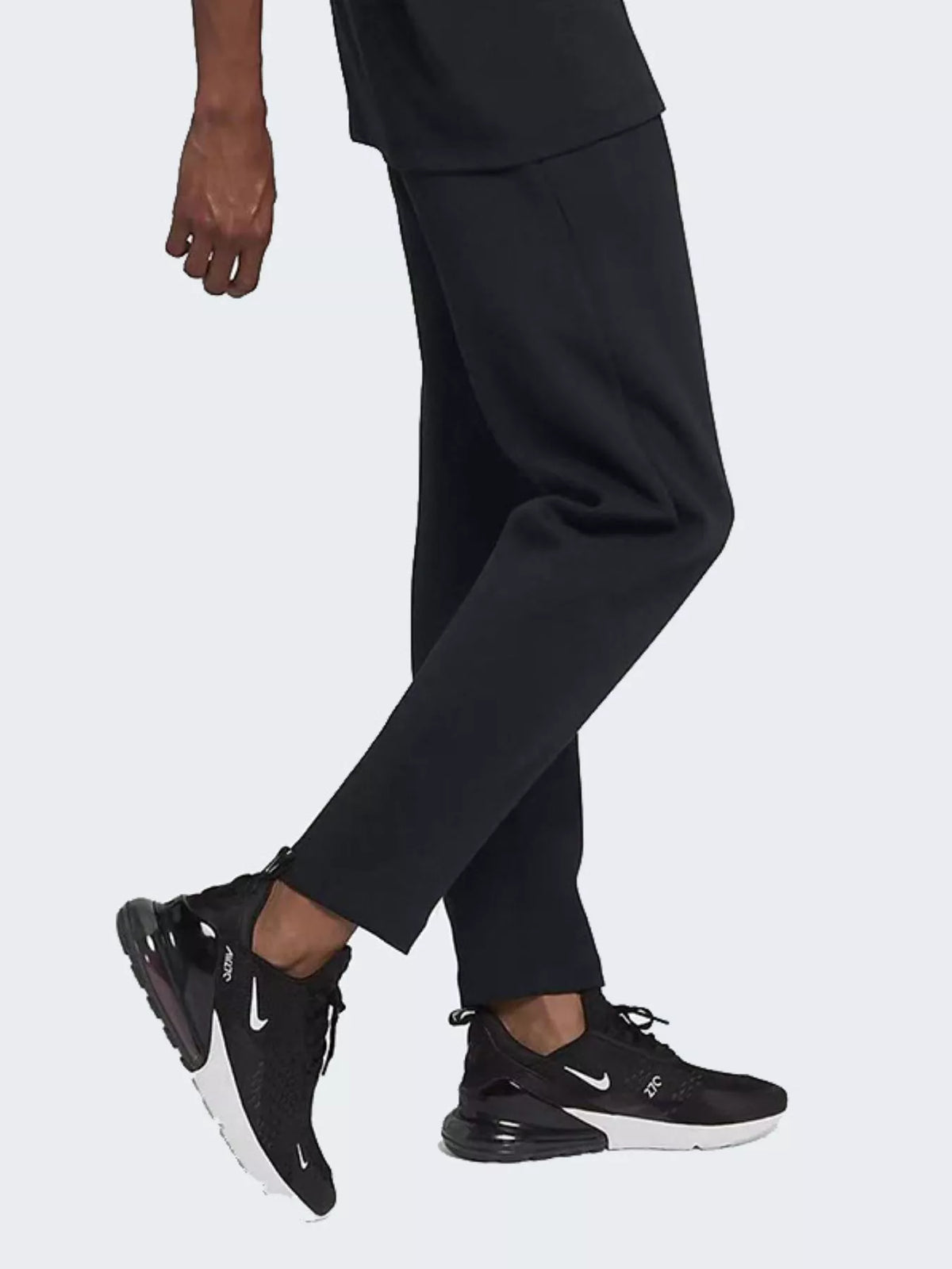 Person wearing black pants and black Nike sneakers on a white background-BlackOrvani