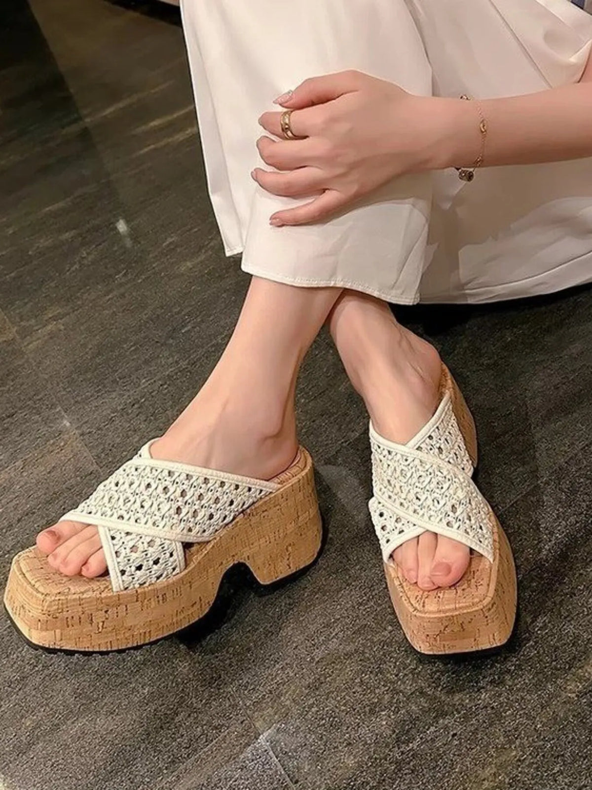 White woven sandals with cork platforms worn by a person on a dark wooden floor-blackorvani.com