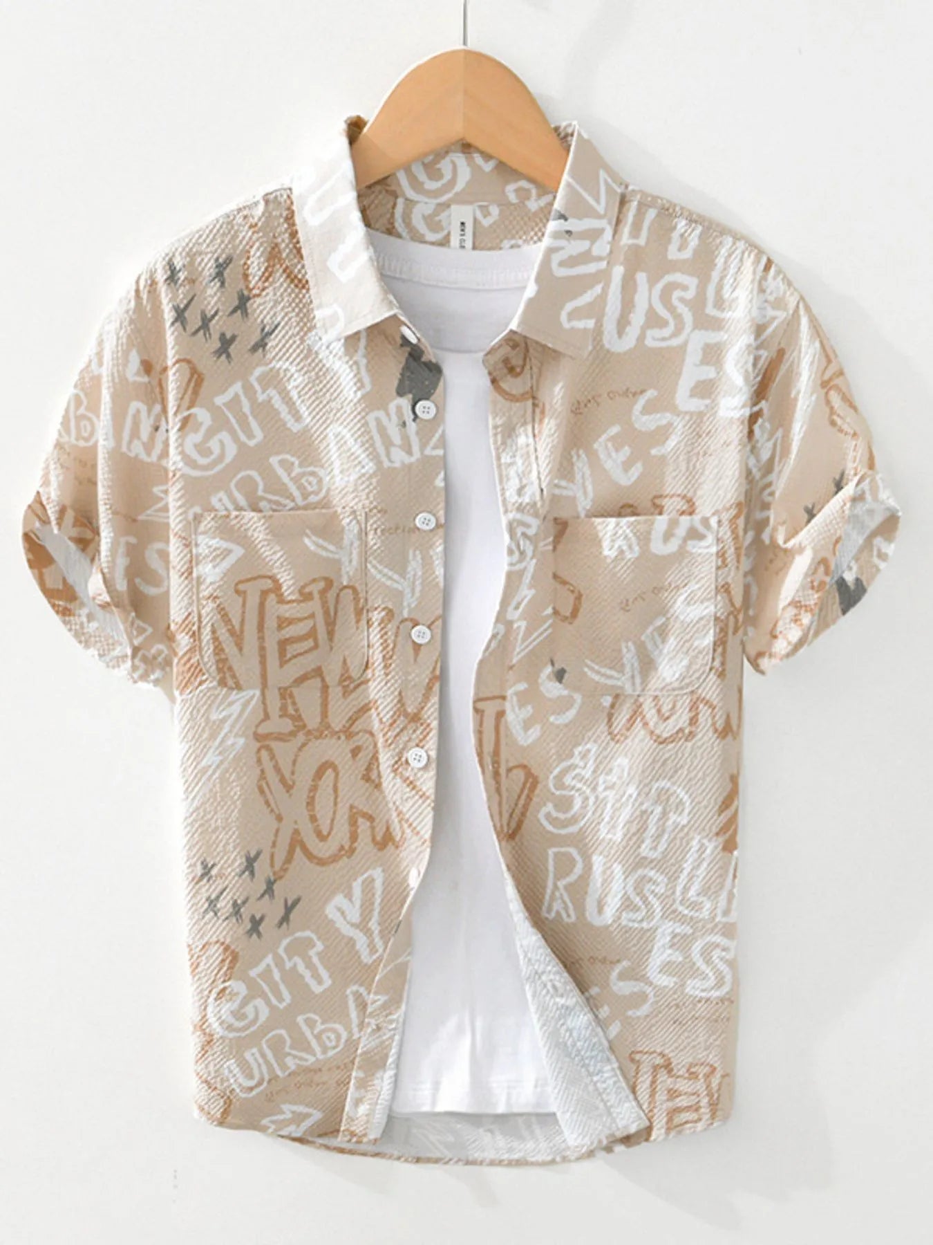 Beige shirt with text pattern on a wooden hanger against a white background-blackorvani.com