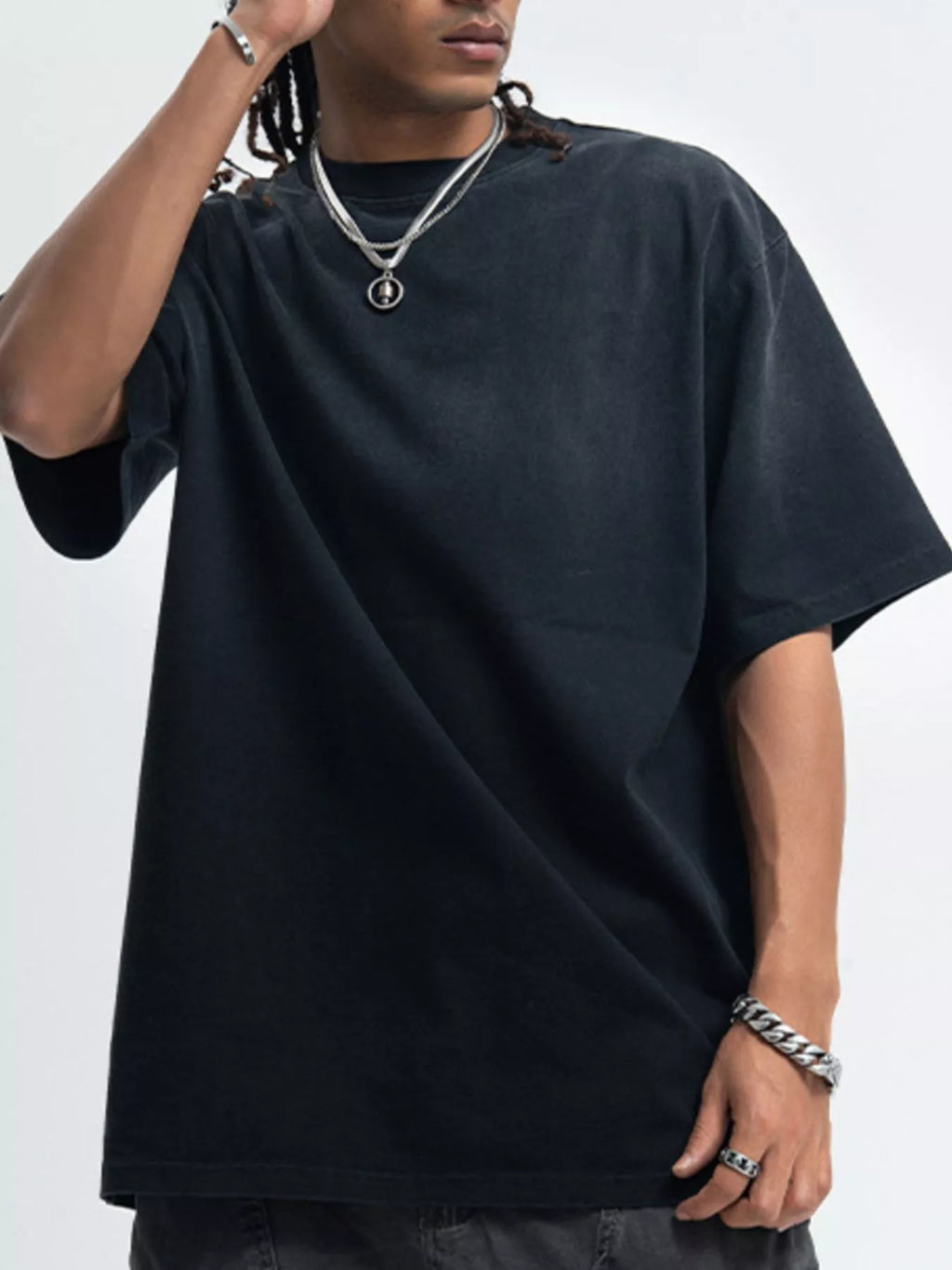 Person wearing a black oversized t-shirt on a white background-blackorvani.com