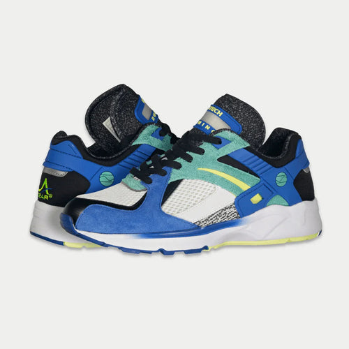 Colorful sneakers with blue, green, and black design on a light gray background